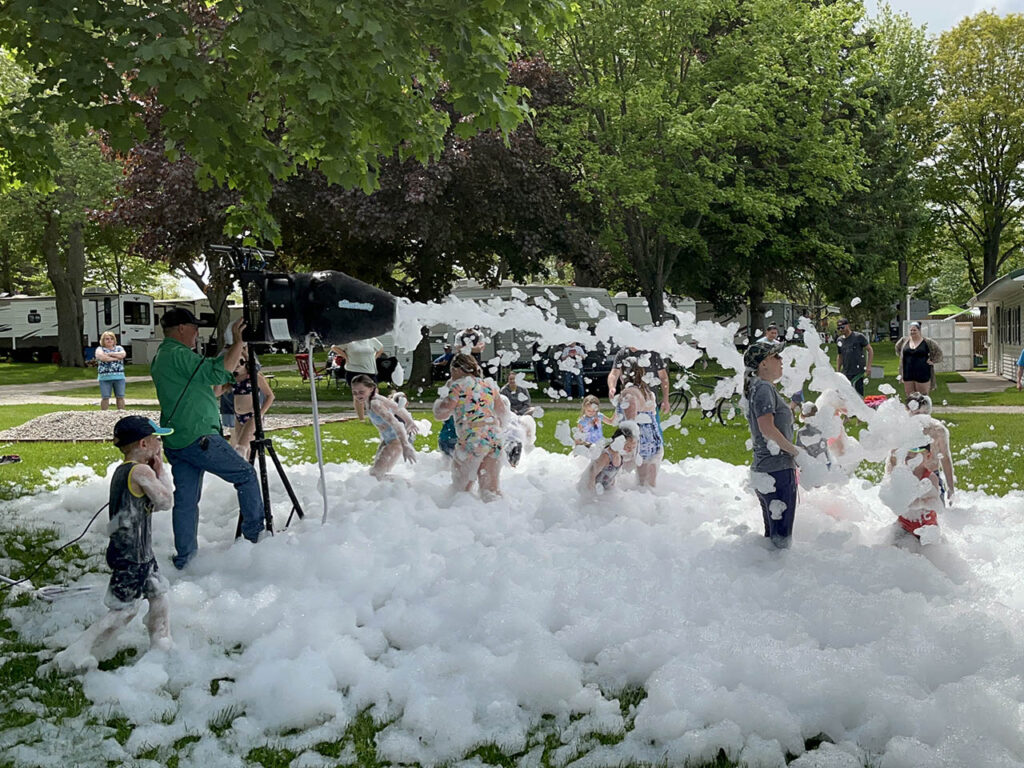 Kids getting blasted with foam from the foam party blaster