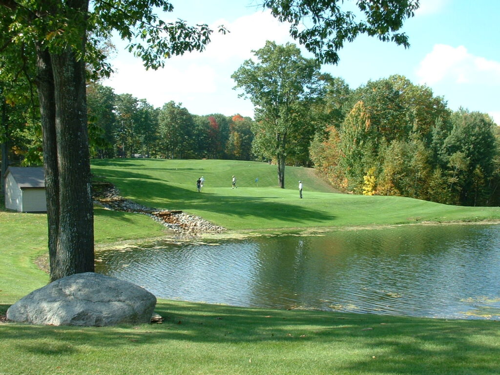 Image of a lake with golf in the background