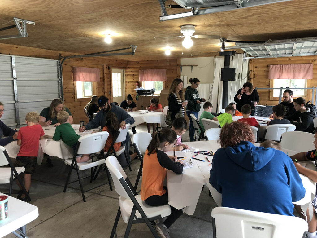 Campers partaking in an indoors art event